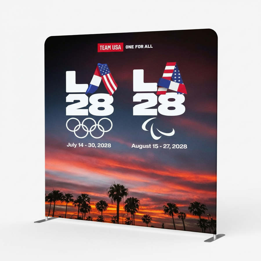 Promotional backdrop for LA 2028 Olympics with palm trees and sunset design.